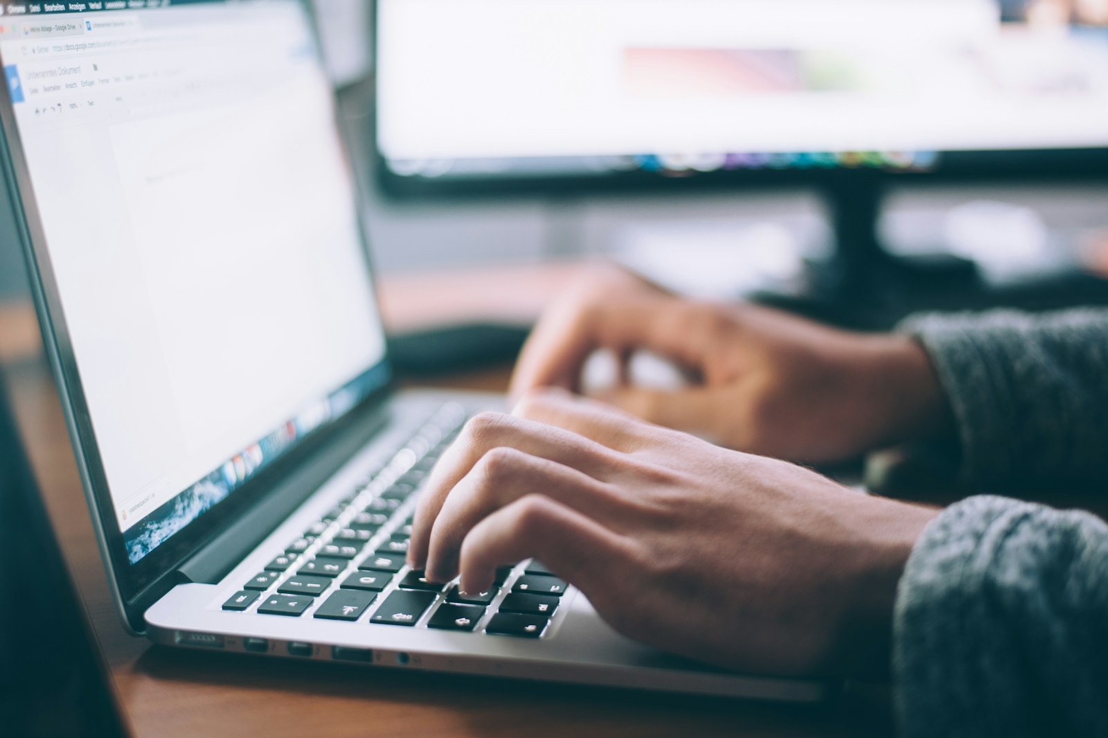 Hands typing on a laptop during desk-based analysis