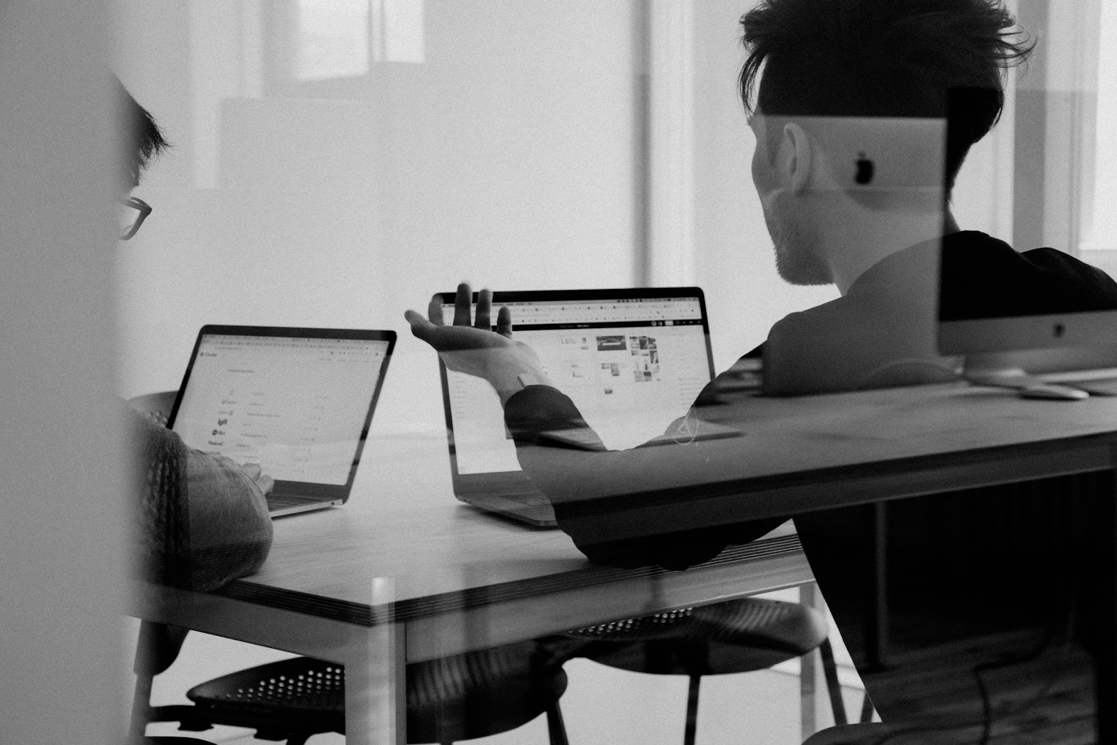 A small professional discussion around laptops in a quiet office