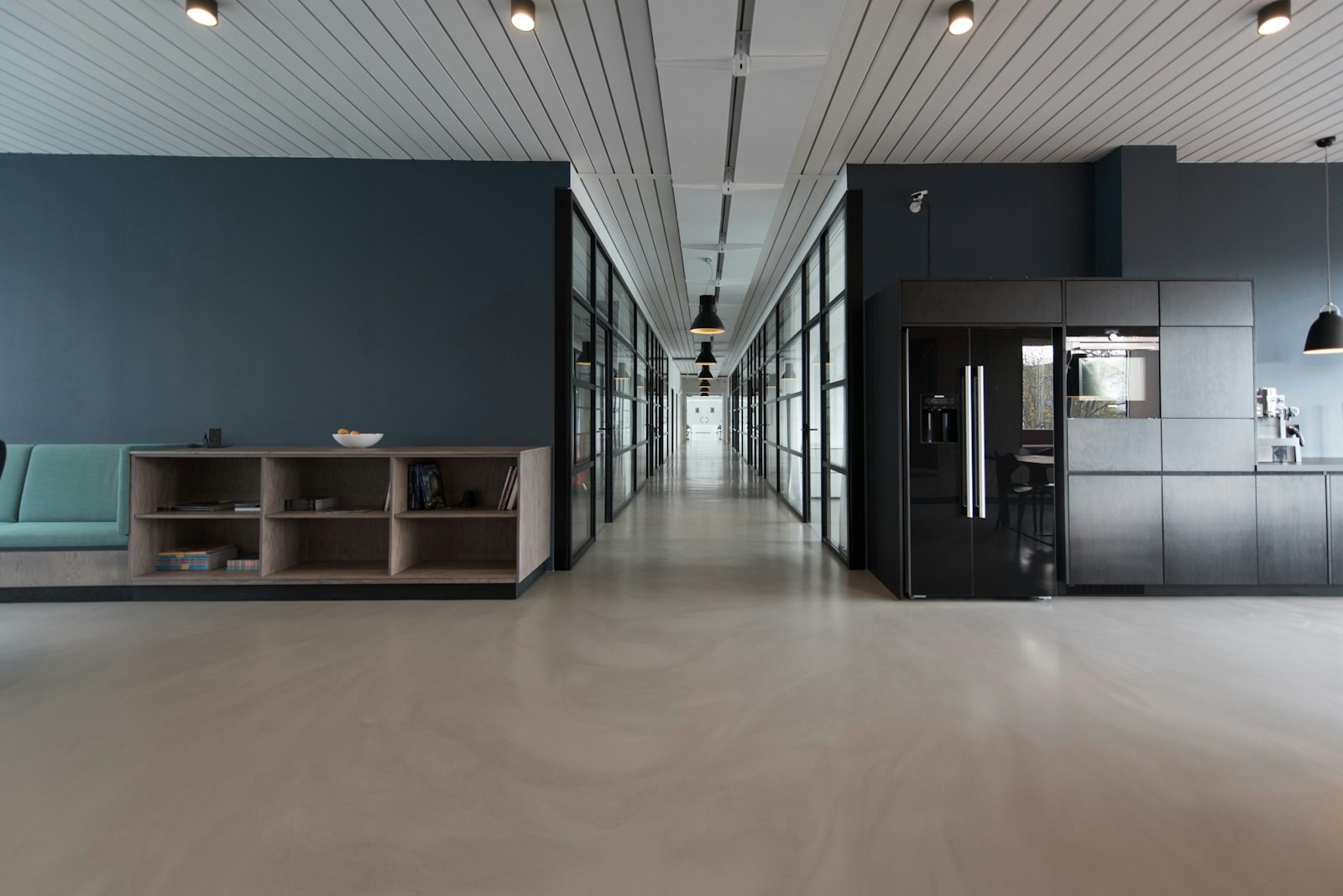 A calm, contemporary professional office interior with meeting rooms and natural light